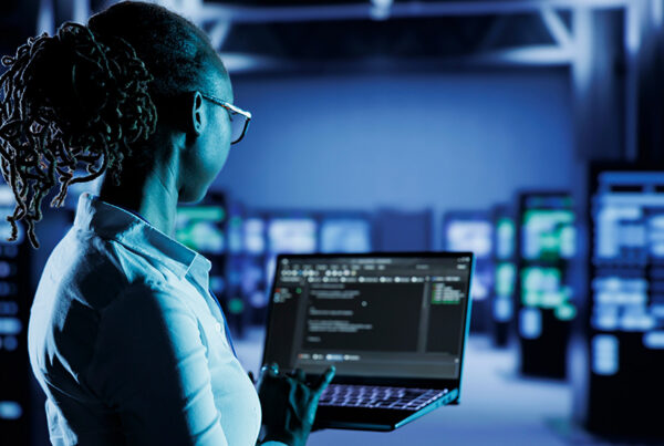 IT technician typing on computer to operate self managed software