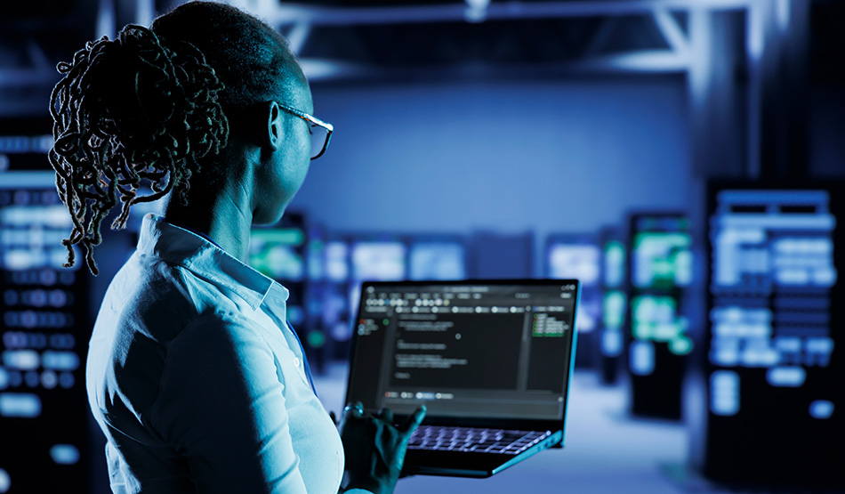 IT technician typing on computer to operate self managed software