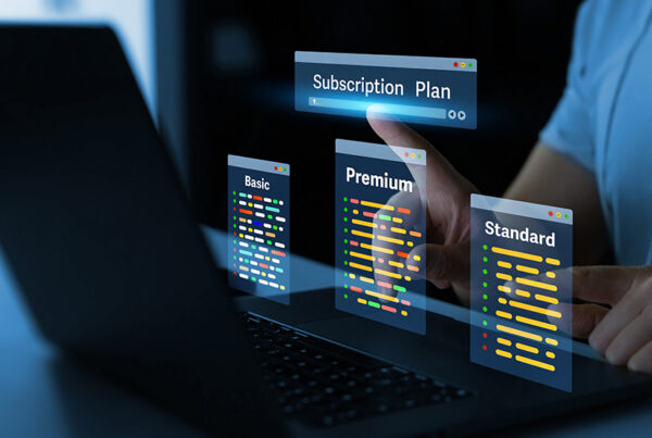 woman typing on a laptop with view of three subscription pricing plans in foreground