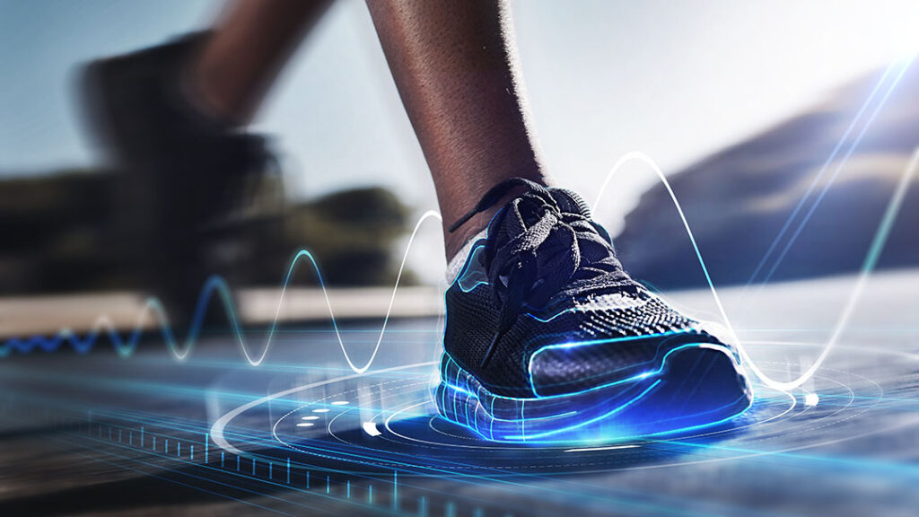 image of a runner planting their front foot on the track with abstract holographic image of the digital health signals being captured by a fitness app