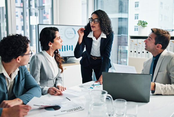 account based marketing team in a brightly lit conference room discussing sales strategy