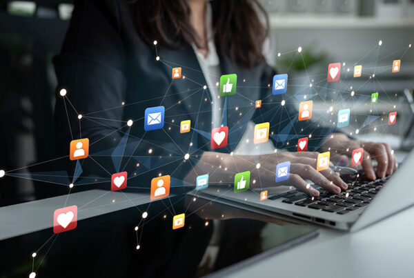 young woman typing on laptop with social media advertising