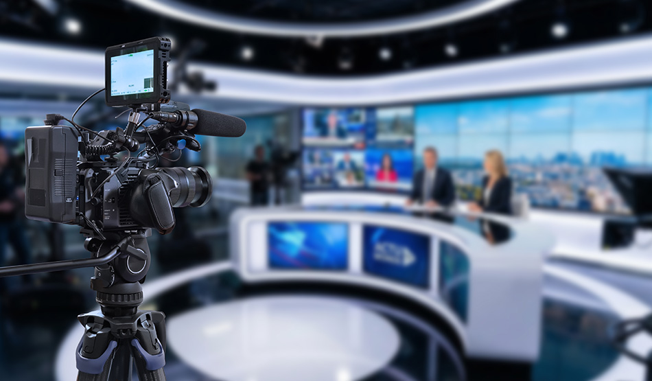video camera in foreground with podcast interview of expert in background