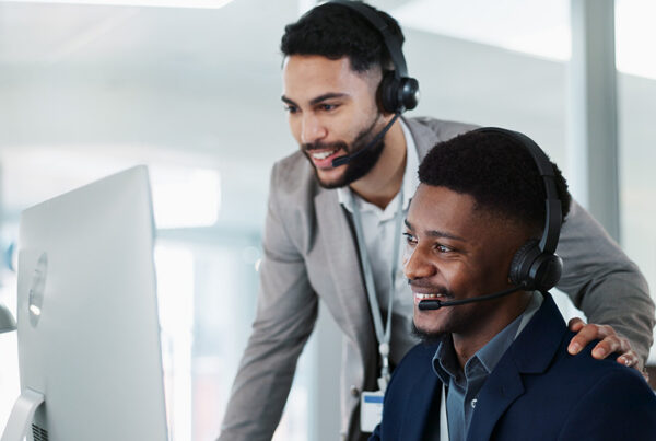 two sales development representative with headsets cold calling prospects to book leads